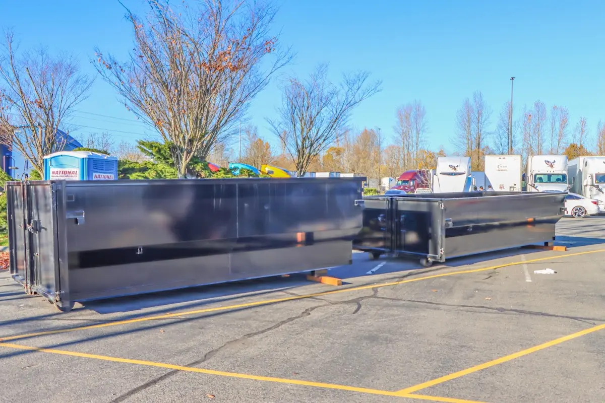 Professional dumpster rental service with roll-off container on residential driveway in Menifee